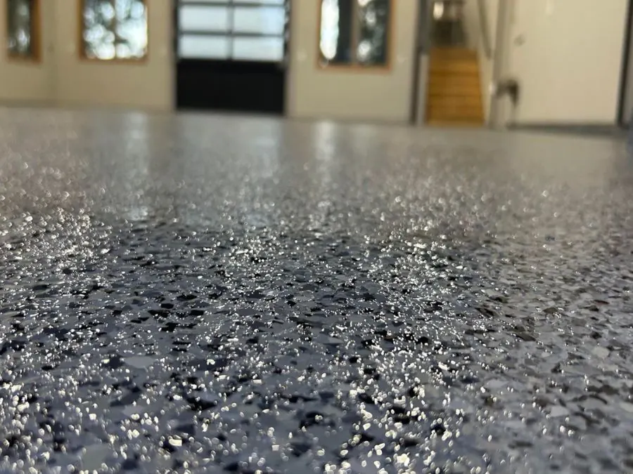 Grey flake epoxy garage floor coating with staircase in Springfield, MO
