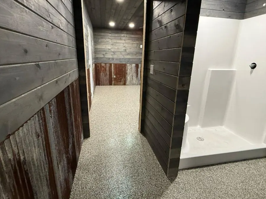 Flake epoxy floor coating in a Springfield, MO basement hallway with rustic wood walls
